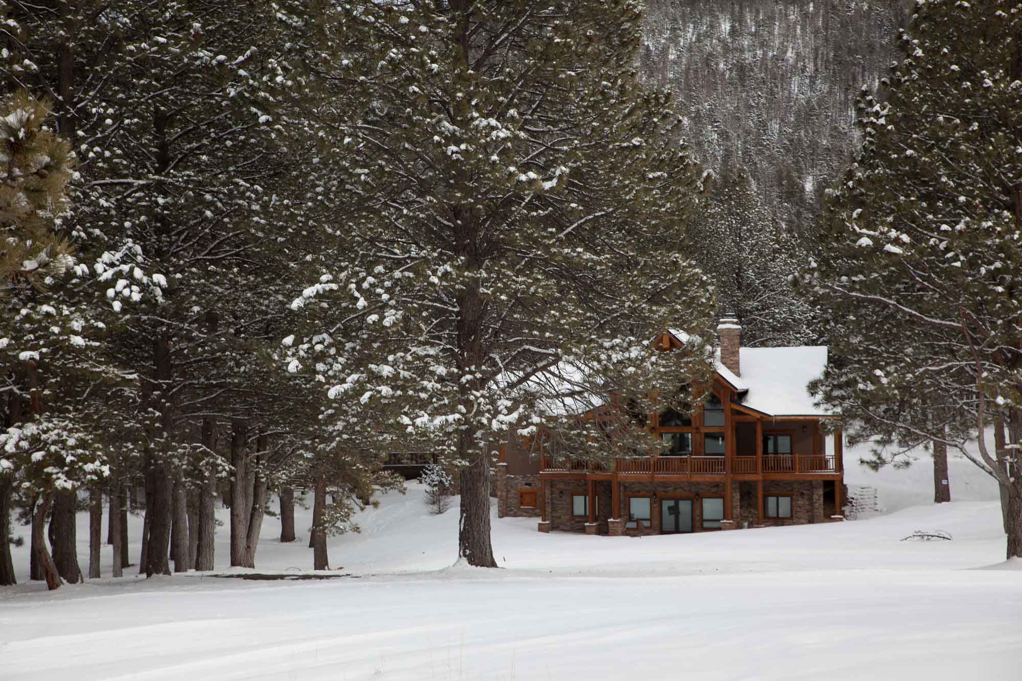 snowy log cabin in the sangre de cristos