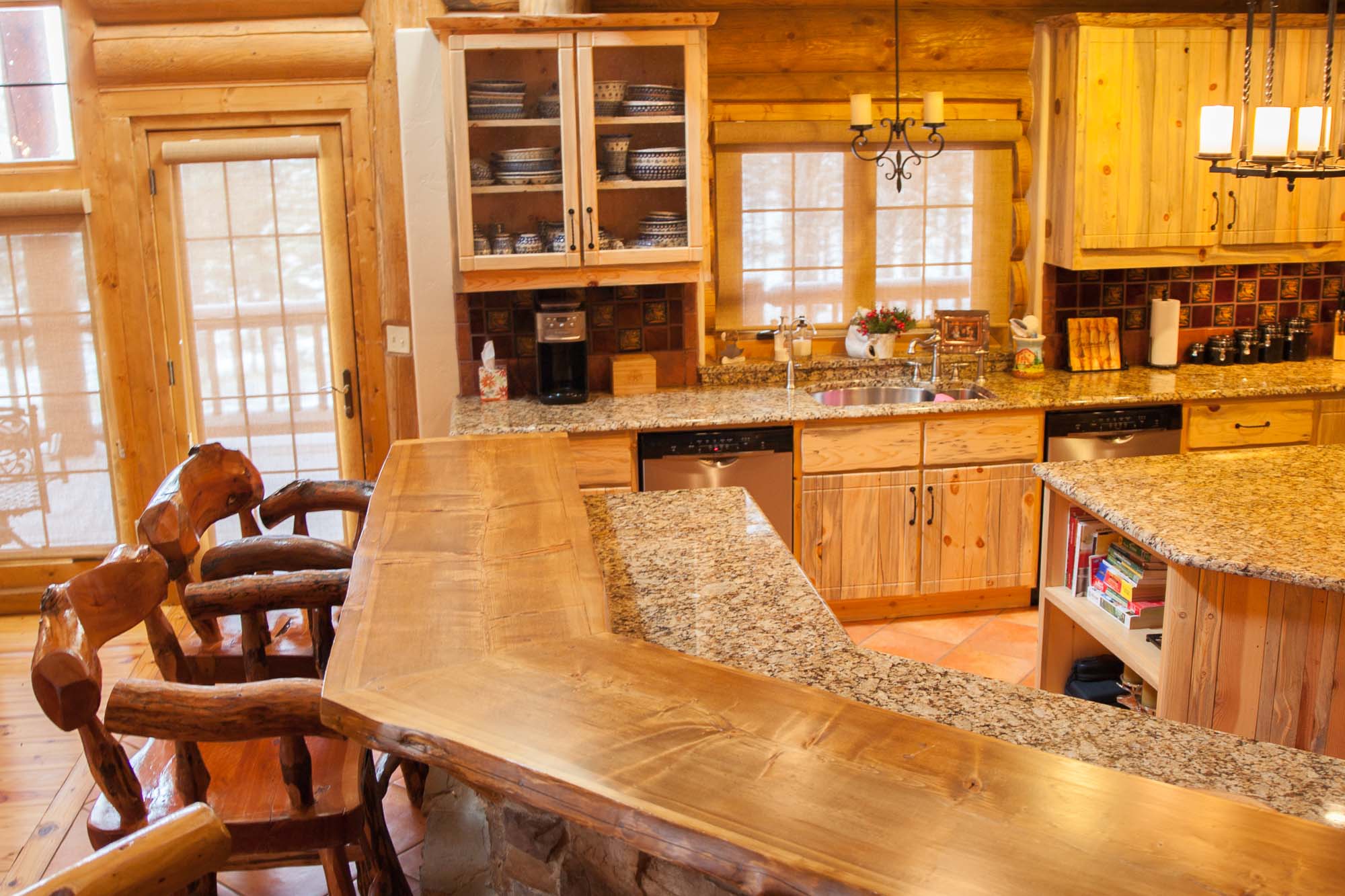 Granite Counter Tops. Custom designed & built log home kitchen in Northern New Mexico by Mammoth Mill & Construction